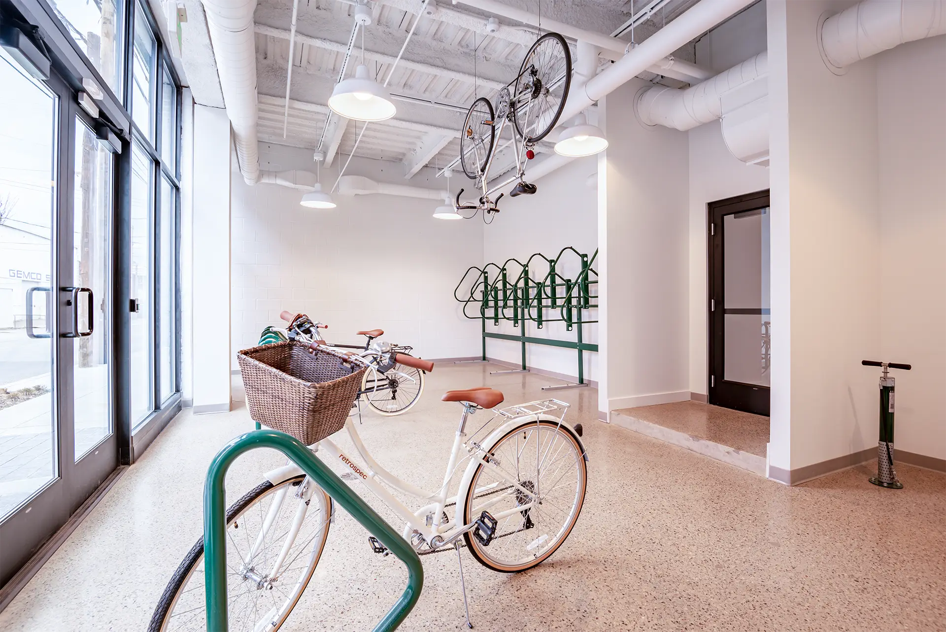 An interior view of a common area used for bike storage with indoor bike racks.